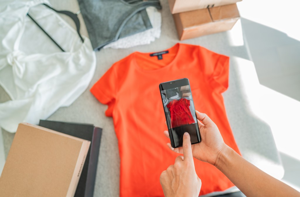 Seller taking a photo of clothing