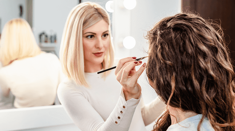 Make-up artist applying makeup to client