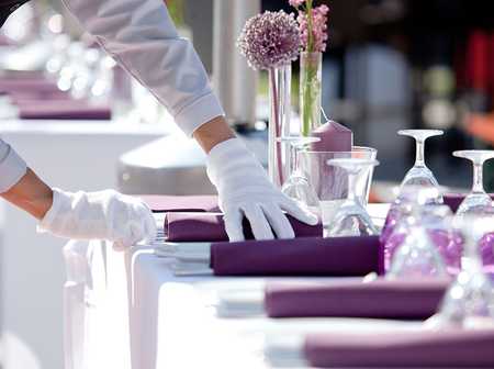 Waitress dressing a table for an event