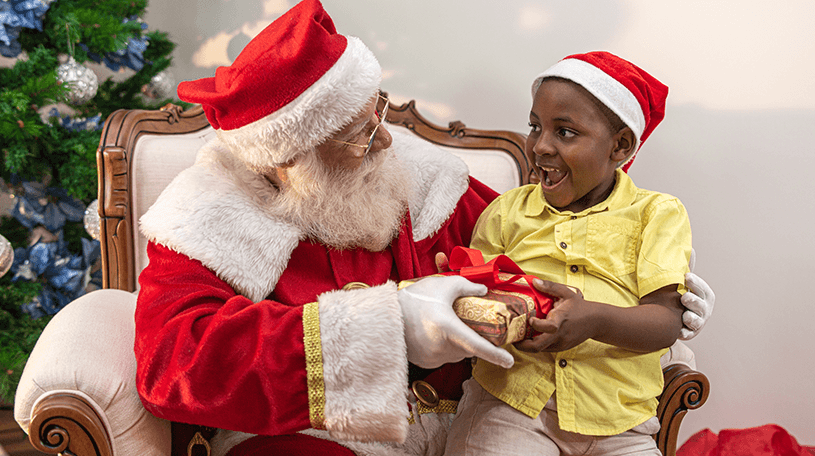 Santa giving a gift to a small boy