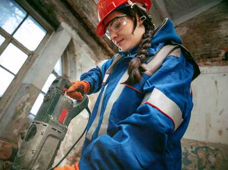 Woman using an industrial drill