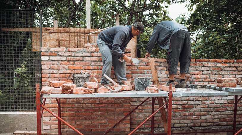 Bricklayers building a wall