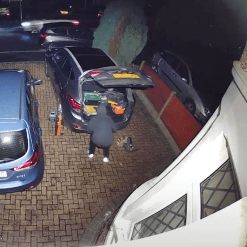 Tool thief stealing tools from car outside home