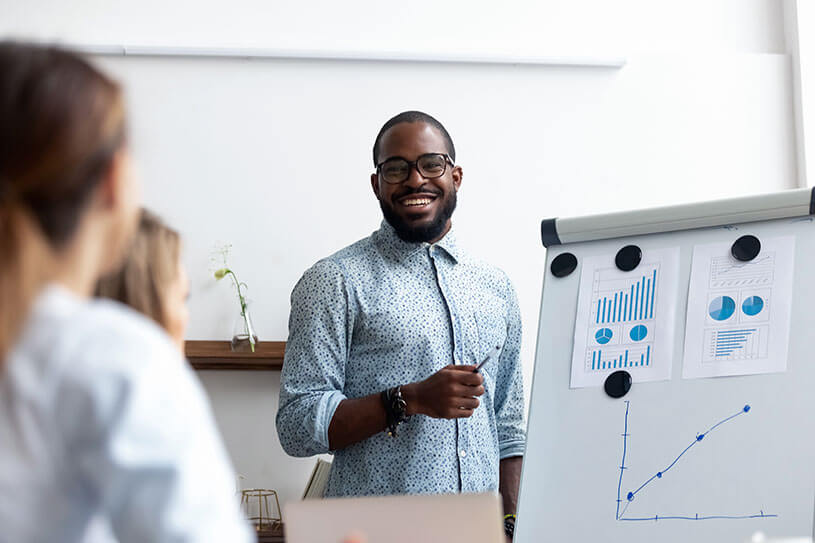 Business owner delivering financial presentation on market share