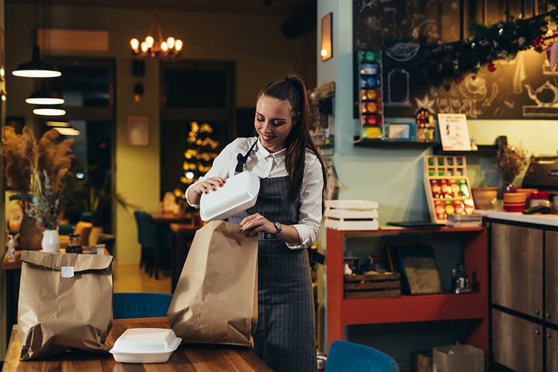 Waitress preparing takeaway food in a restaurant