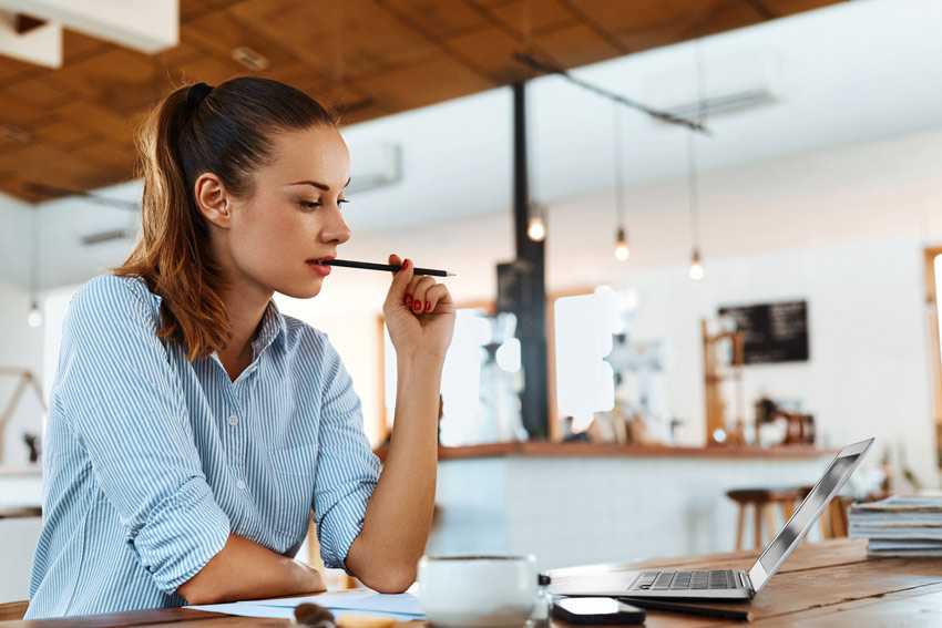 Women writing a social media plan in a coffee shop
