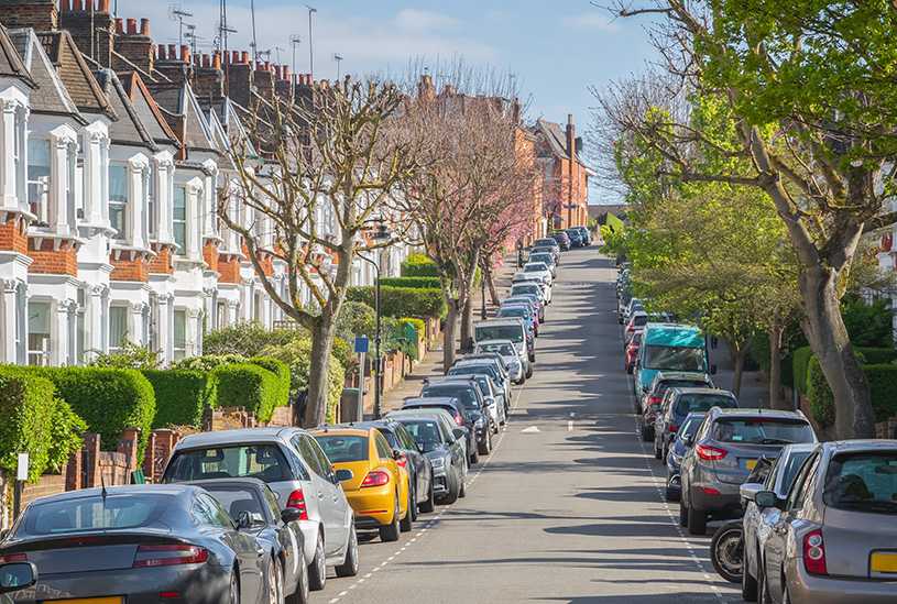 UK residential street with parked cars