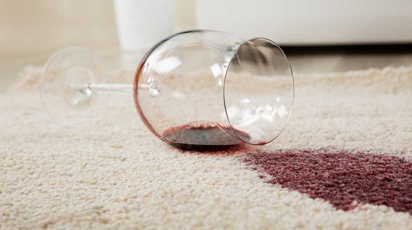 Glass of wine spilt on cream coloured carpet
