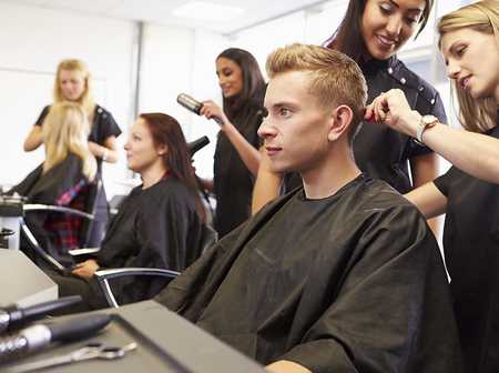 Clients having hair cuts in a hair salon