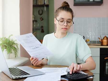 Woman using calculator to work on budgets