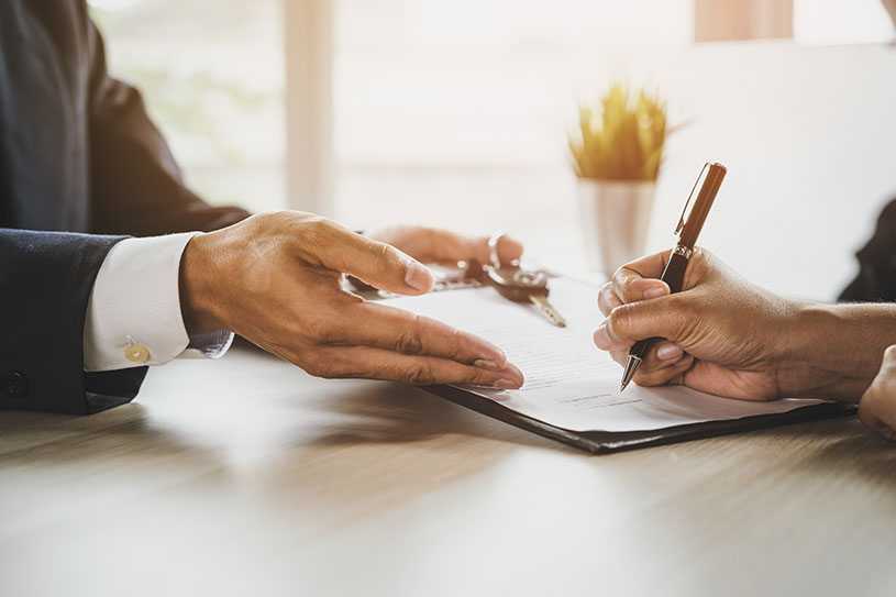 Two people signing a lease agreement