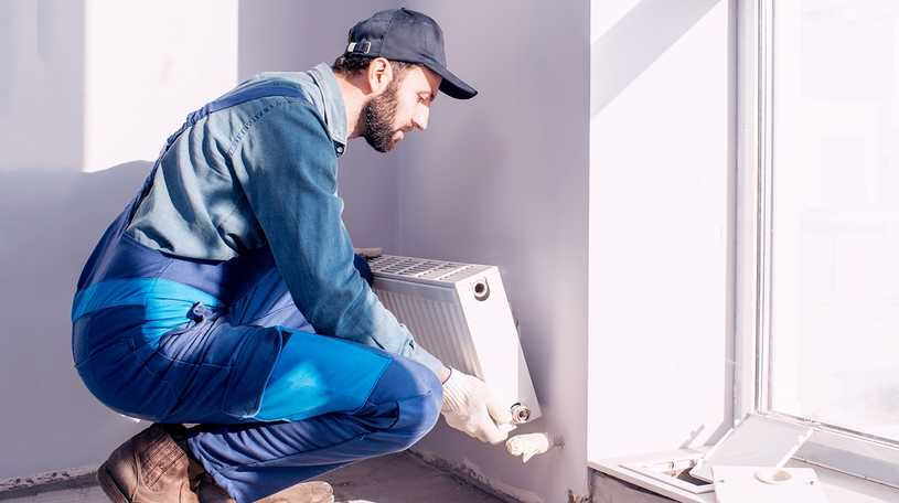 Man installing a radiator