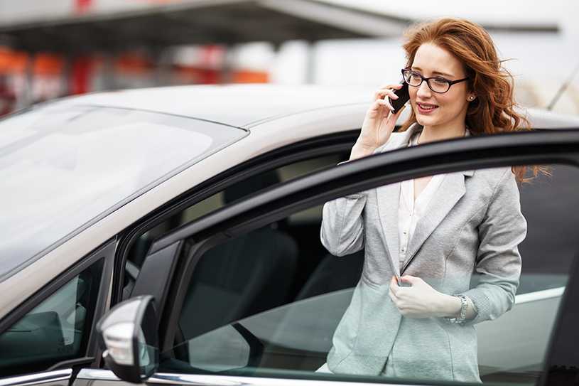 Woman on the phone outside company car