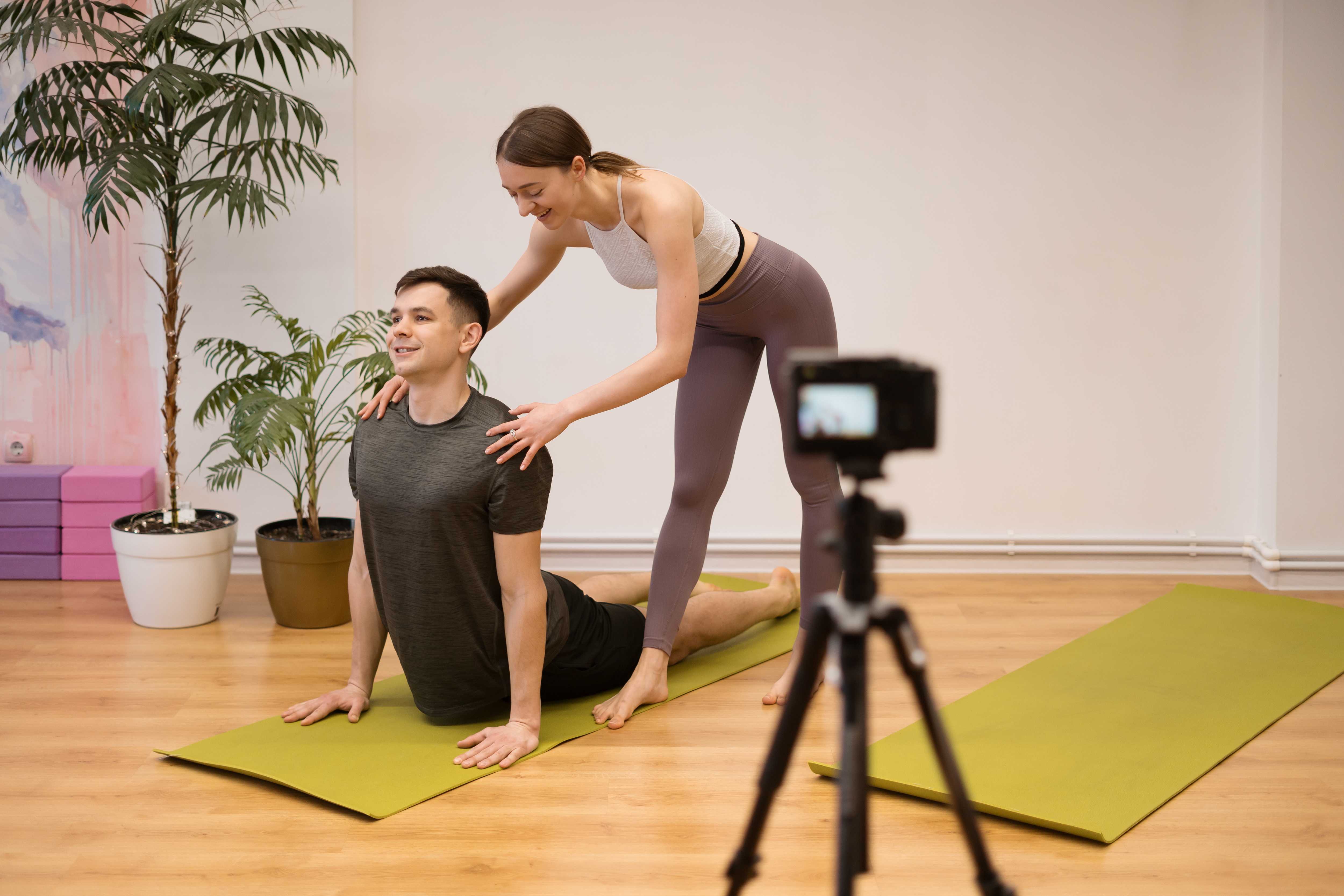 Yoga teacher filming online yoga class