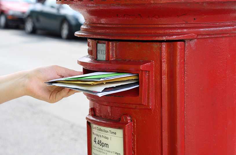 Posting letters in British post box