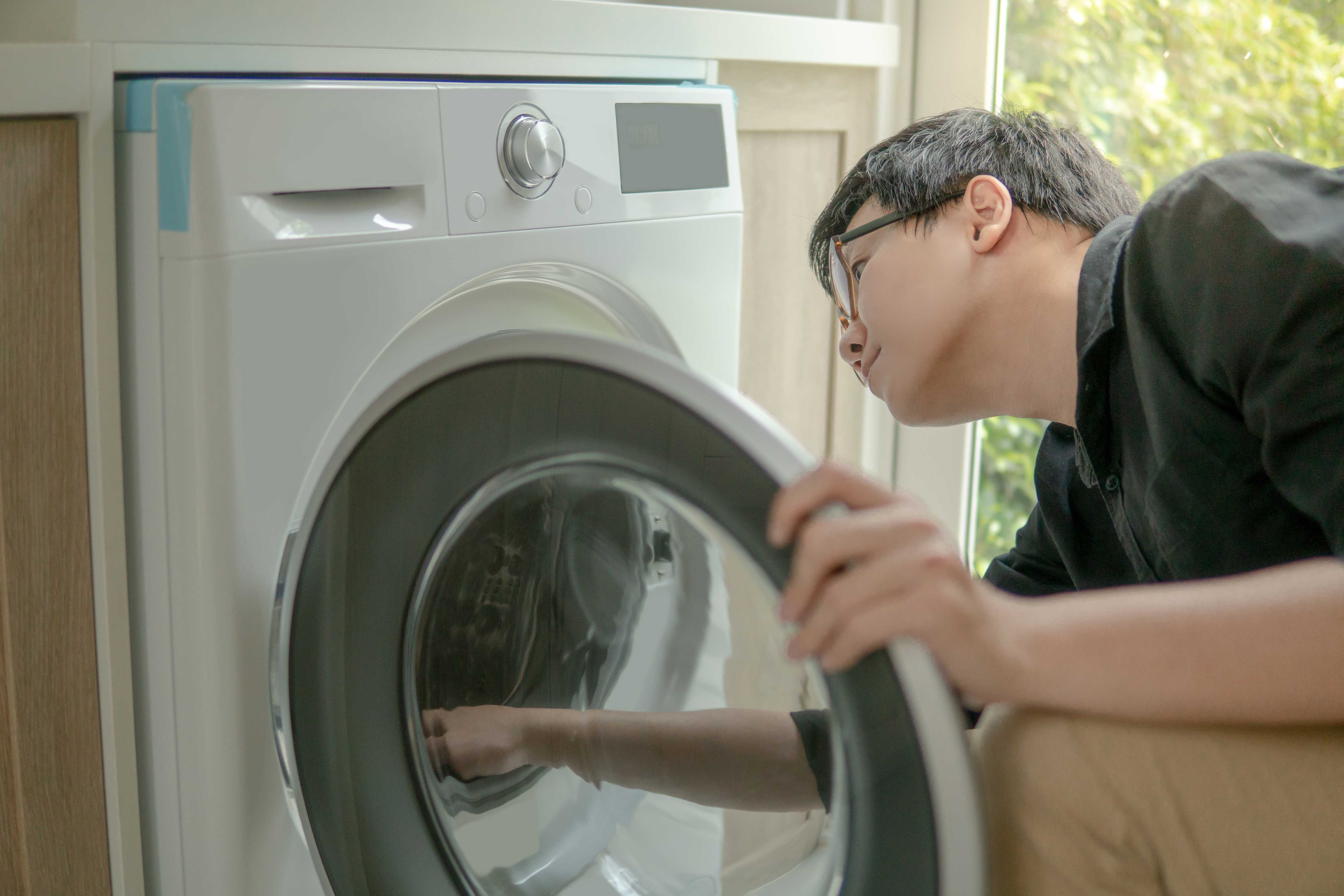 Landlord checking a washing machine