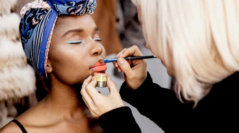 Make-up artist applying make-up to a model