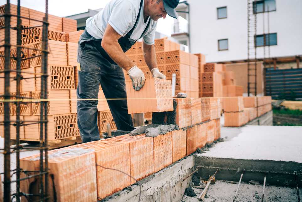 Man building brick wall