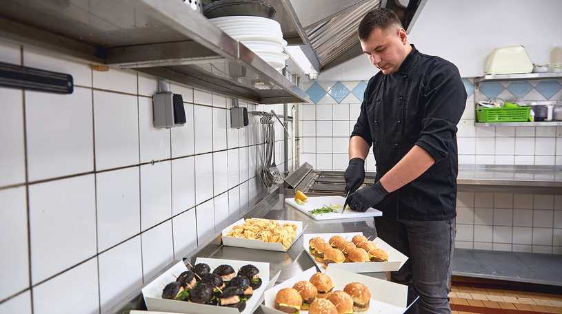 Caterer preparing entree platters in the kitchen