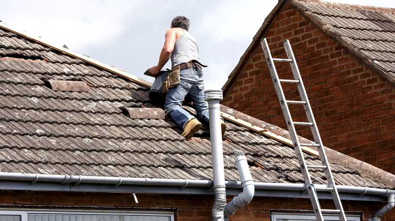 Roofer installing roof tiles