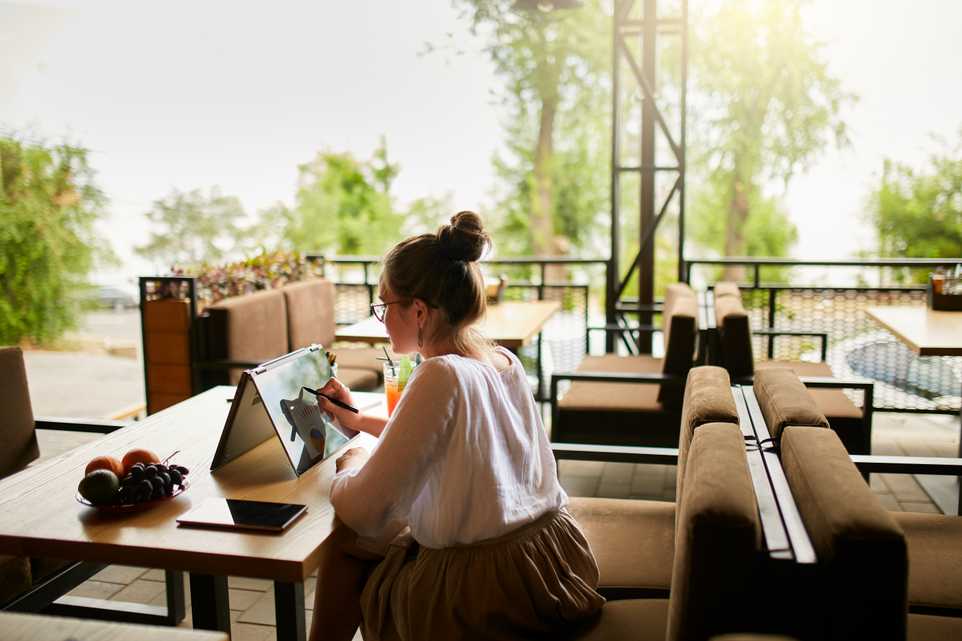 Woman working remotely at a cafe