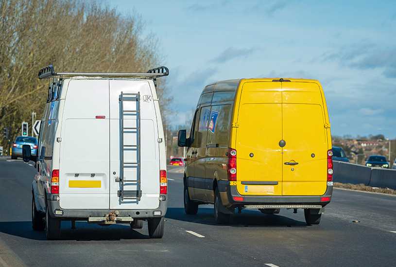 Two business vans driving on a UK road