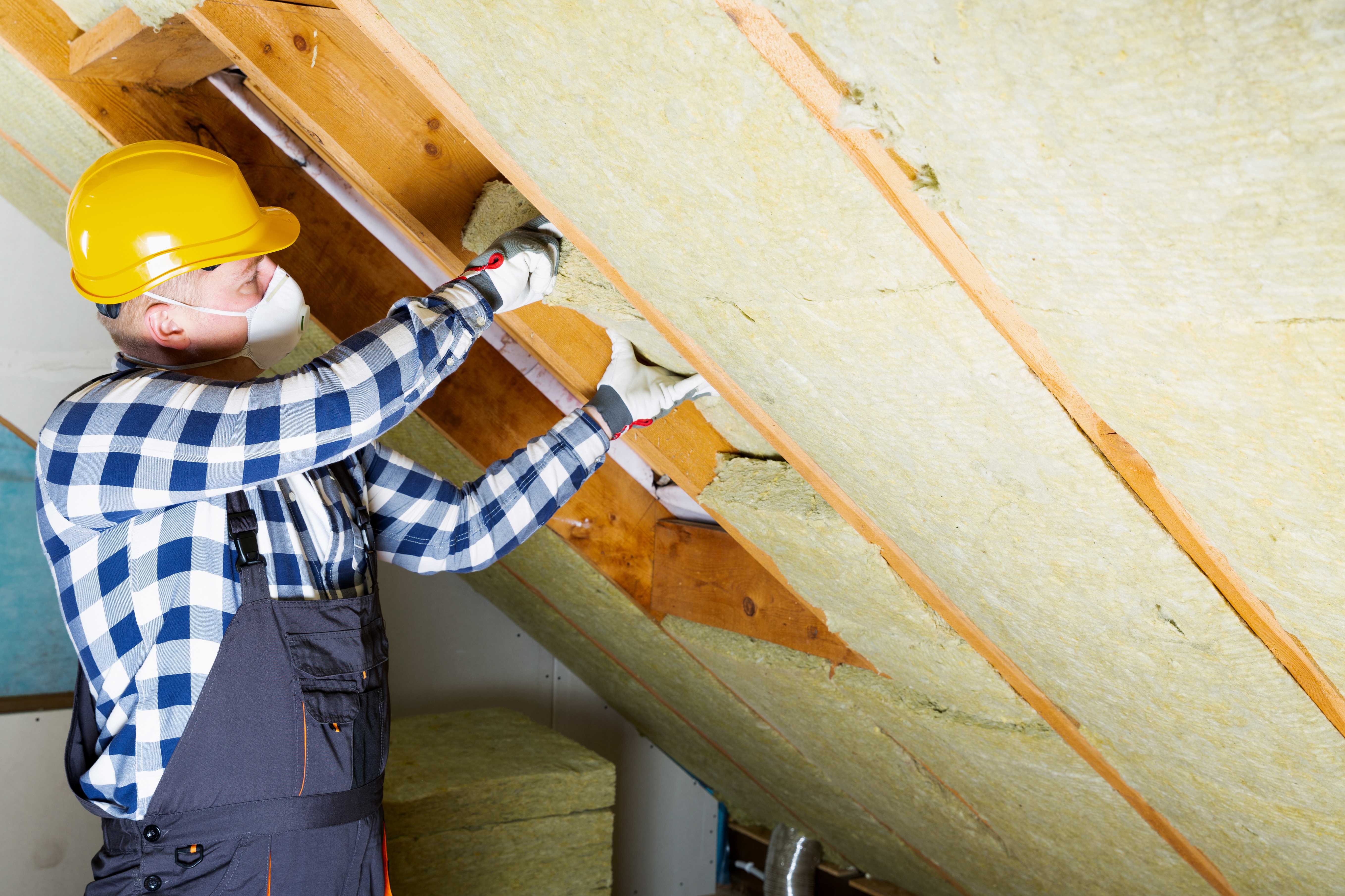 Roofer installing insulation