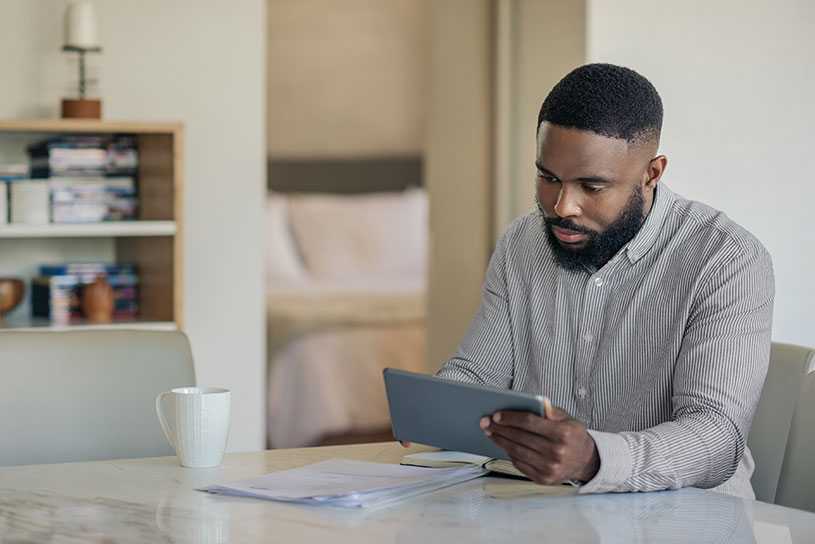 Man doing online banking on a tablet
