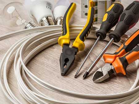 A collection of electrical tools, such as wire, screwdriver and pliers