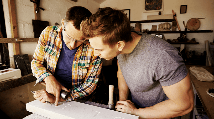 Two workmen discussing planning documents