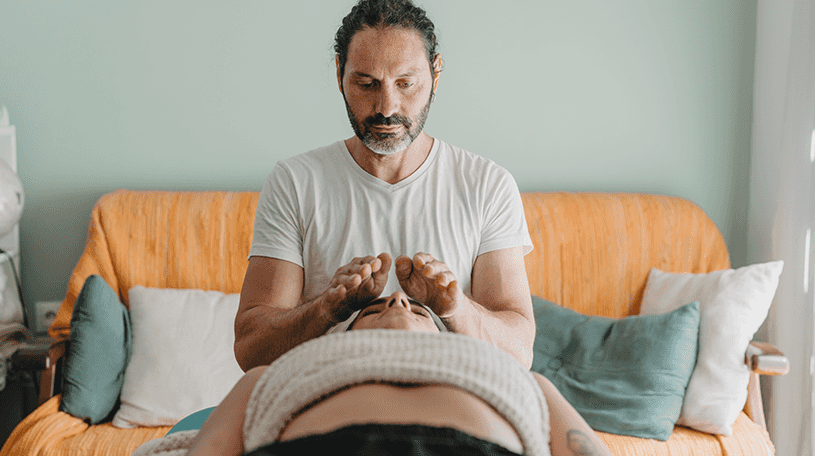 A reiki instructor working on a client