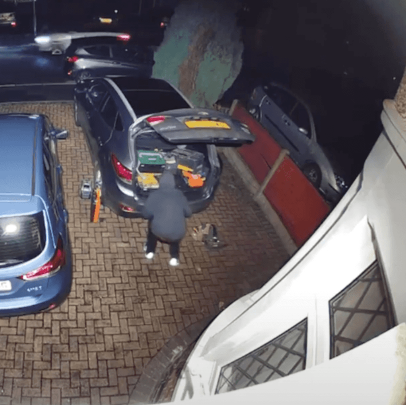 Tool thief stealing tools from car outside home