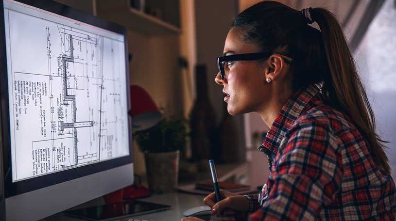 Architect viewing drawings on her computer