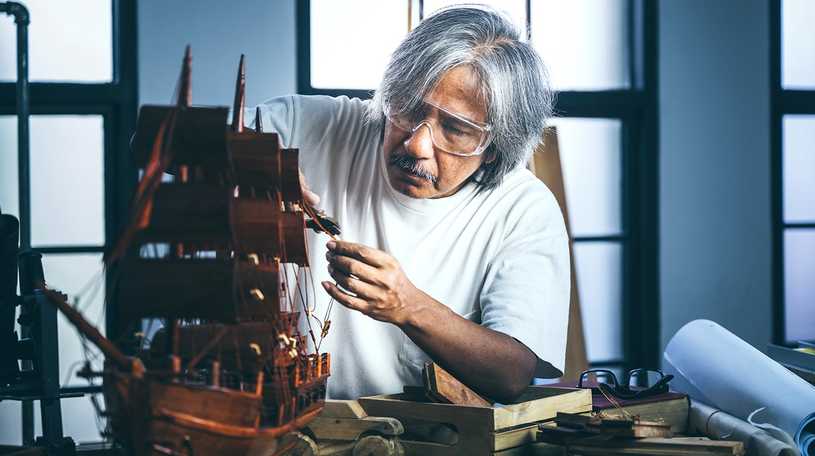 Man building a wooden ship