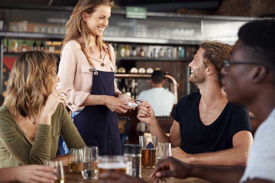 People paying for drinks in a restaurant