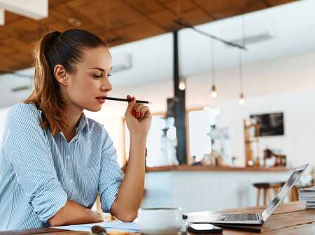 Women writing a social media plan in a coffee shop