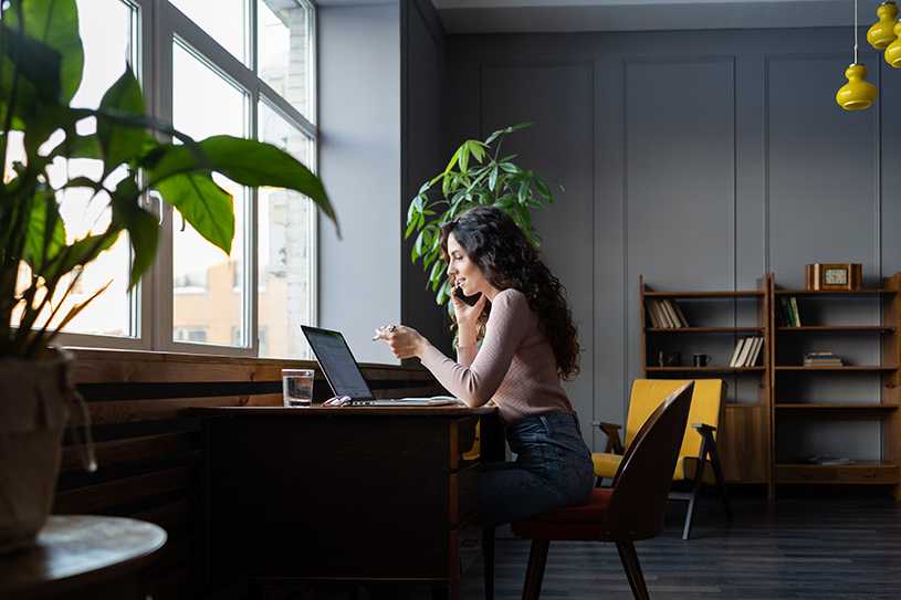 Business woman using a mobile phone in an office