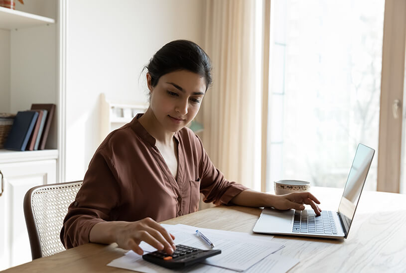 Business owner doing a cash flow forecast with a calculator