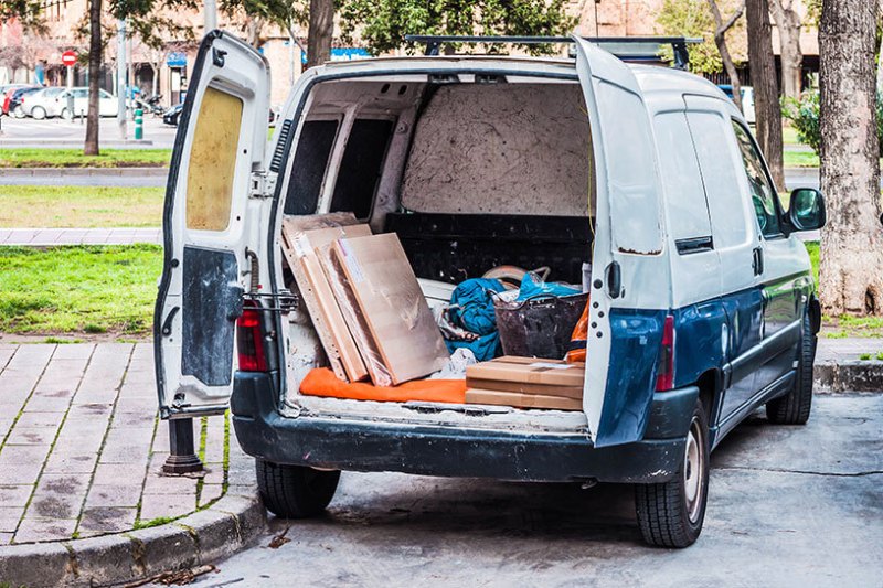 Work van with the door open in the back with working tools inside