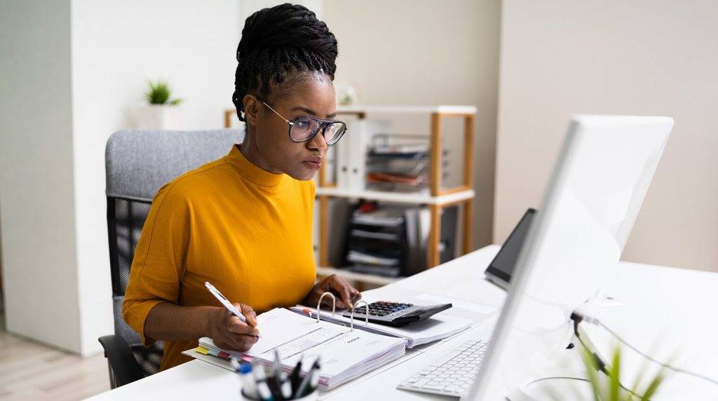 Young accountant working at computer