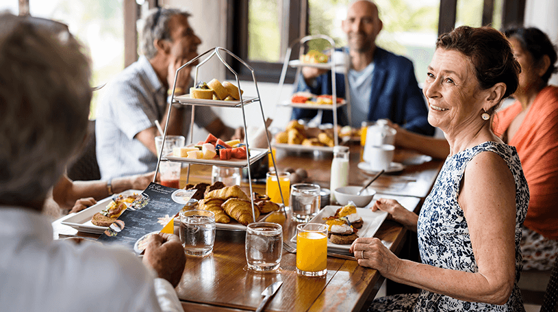 Six people sat around a breakfast table