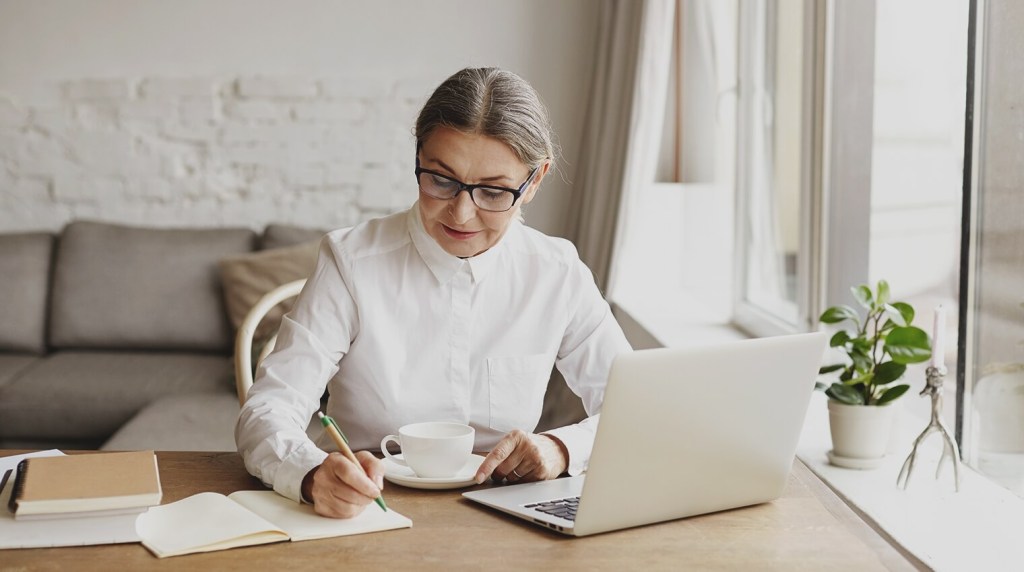 Bookkeeper writing in ledger