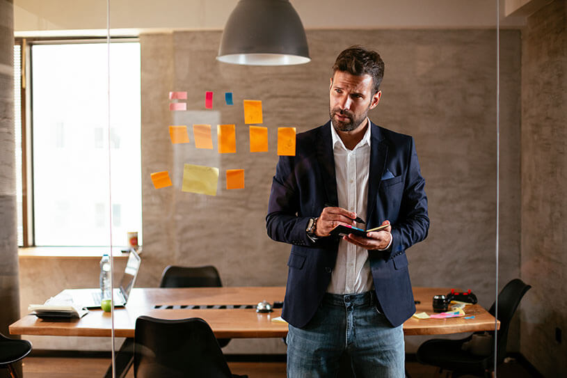 Businessman working on business names and ideas with Post-it notes