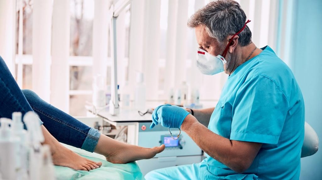 Chiropodist preparing to work on patient‘s foot