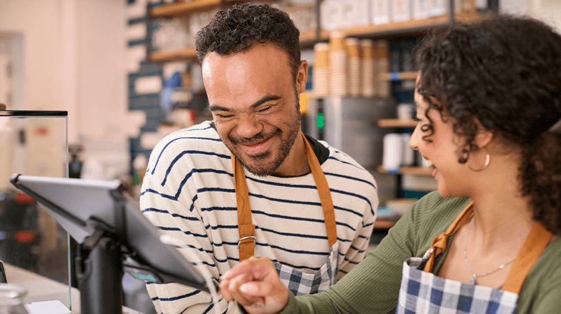 Male sales assistant serving a customer at the till