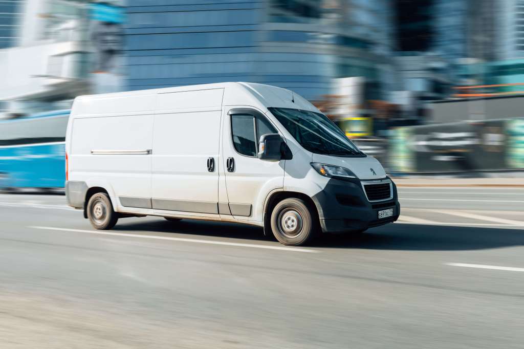 Van driving through a city