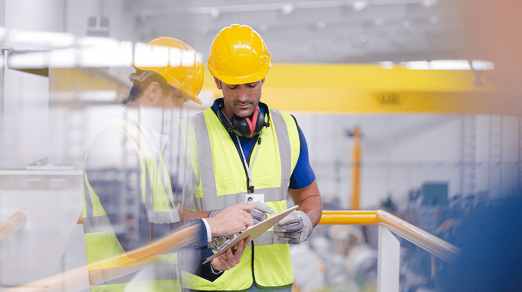 Electrical engineers discussing information on a clipboard