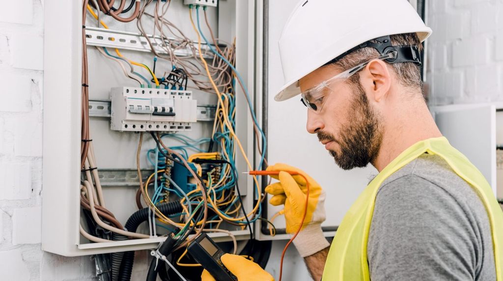 Electrician working on fuse box