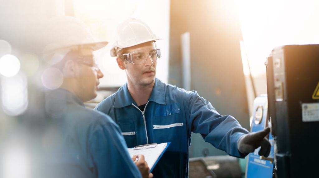 Factory workers checking gauges