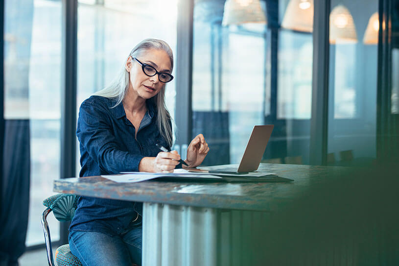 A business owner filling out a health and safety assessment on her computer.